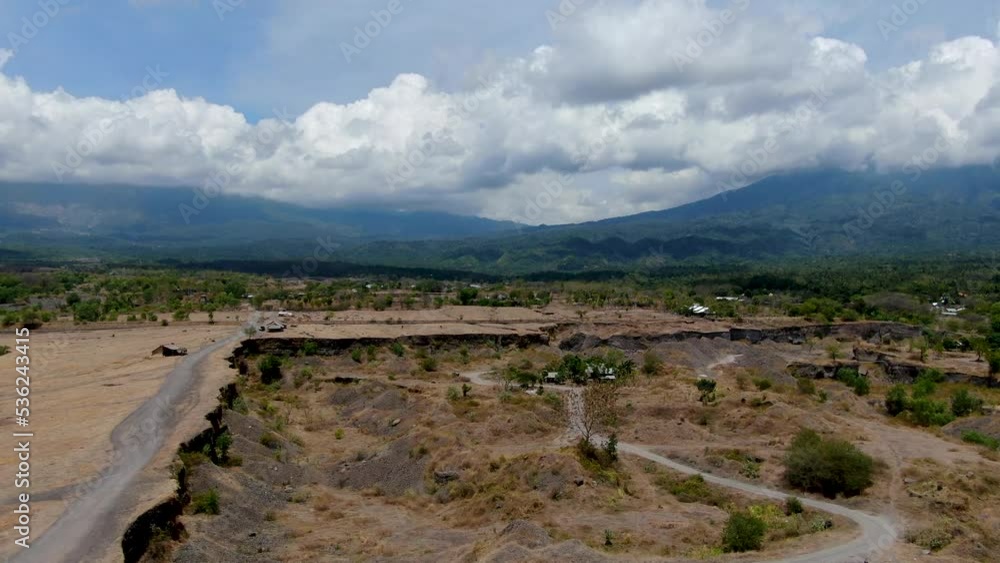 Cloudy mountain range and savannah landscape in Bali island, aerial view Cloudy mountain range and savannah landscape in Bali island, aerial view