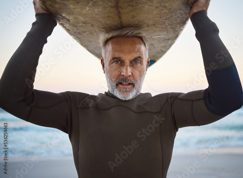 Photography Beach, surf board on head and a mature surfer man with ocean waves and sea sand