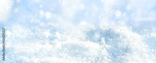 Christmas winter background with blue bokeh light on snow landscape