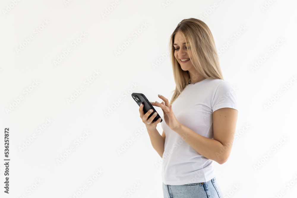 Portrait of happy woman using mobile phone, holding smarphone chatting with friends while sitting at home, scroll internet feed, use application, smile at display Portrait of happy woman using mobile phone, holding smarphone chatting with friends while sitting at home, scroll internet feed, use application, smile at display