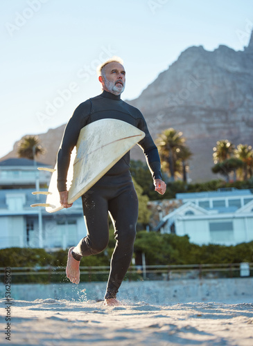 Photography Beach, mature surfer running with surf board on sea sand and weekend water sports