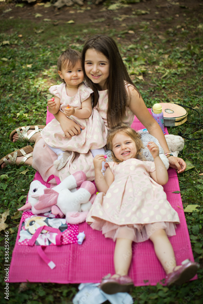 sisters playing in a park on summer day sisters playing in a park on summer day