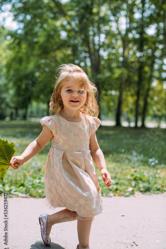 little girl play in a park on sunny day