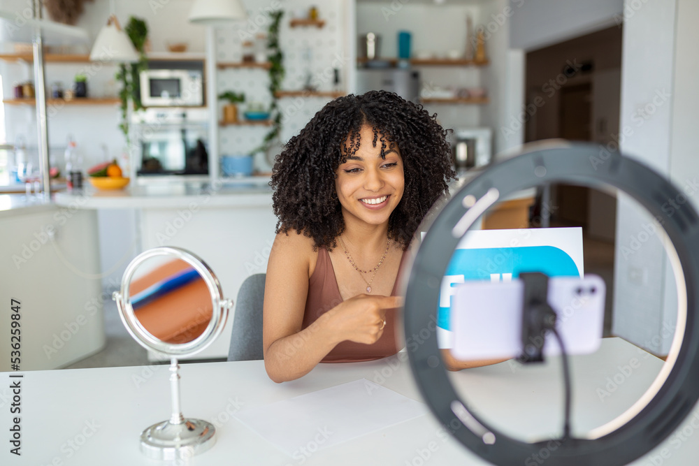 Young female influencer using her smart phone for filming a vlog post. Young female influencer using her smart phone for filming a vlog post.