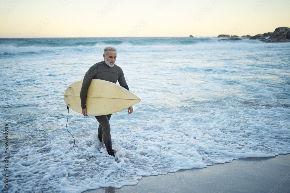 Surfing, surfboard and senior man on beach for water sports while walking  on adventure after riding