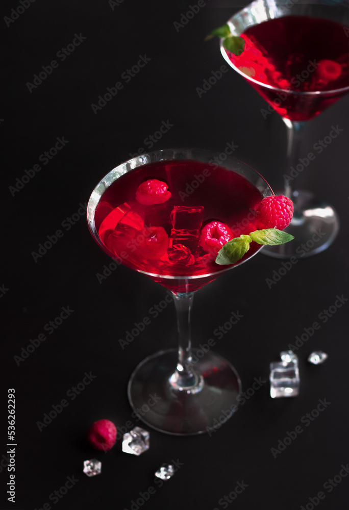 Red alcohol raspberry cocktails in martini glass with mint. Selective focus. Red alcohol raspberry cocktails in martini glass with mint. Selective focus.