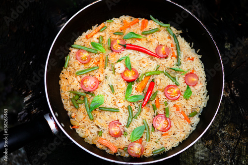 fried rice with shrimp, tomatoes and asparagus in a frying pan