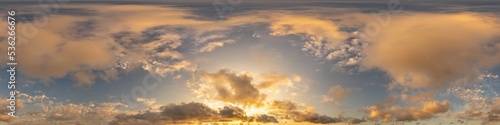 Dark blue sunset sky panorama with golden Cumulus clouds. Seamle