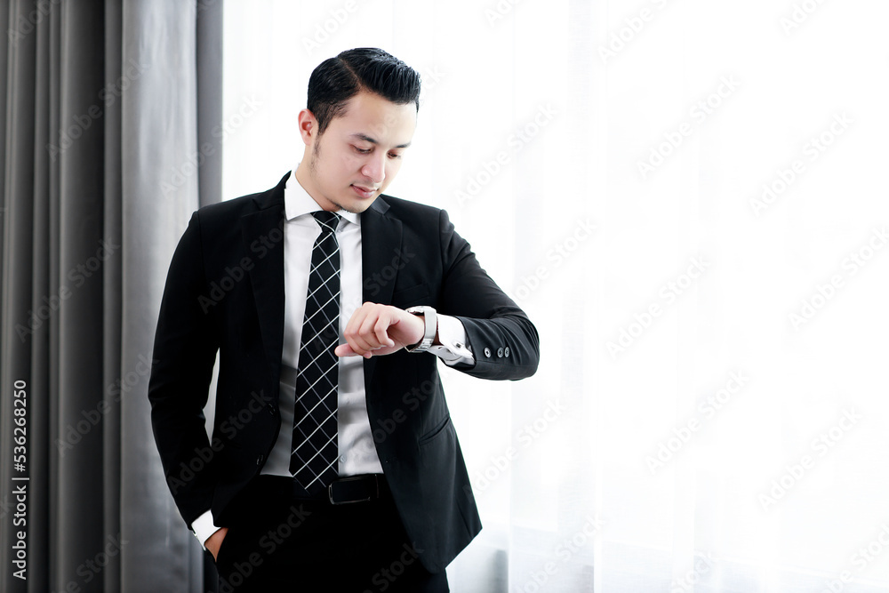 Business handsome man worker in black suit standing in window office glass. Business handsome man worker in black suit standing in window office glass.