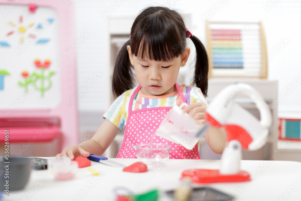 young girl pretend play food preparing at home young girl pretend play food preparing at home