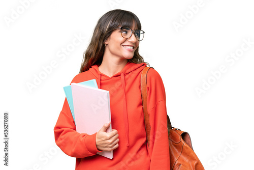 Young student caucasian woman over isolated background looking side photo