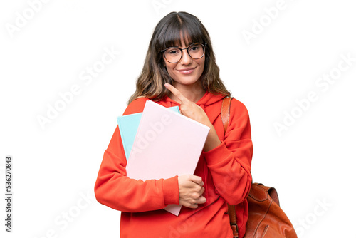 Fototapeta Young student caucasian woman over isolated background pointing to the side to p