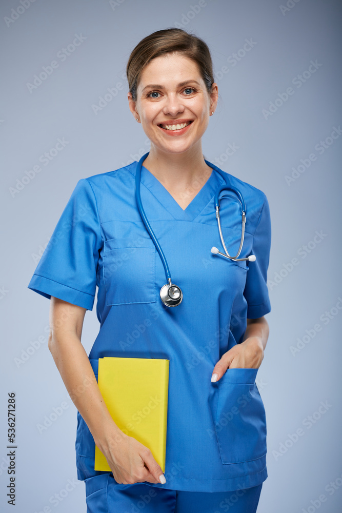 Smiling teacher doctor or woman student with yellow book. Isolated portrait. Smiling teacher doctor or woman student with yellow book. Isolated portrait.