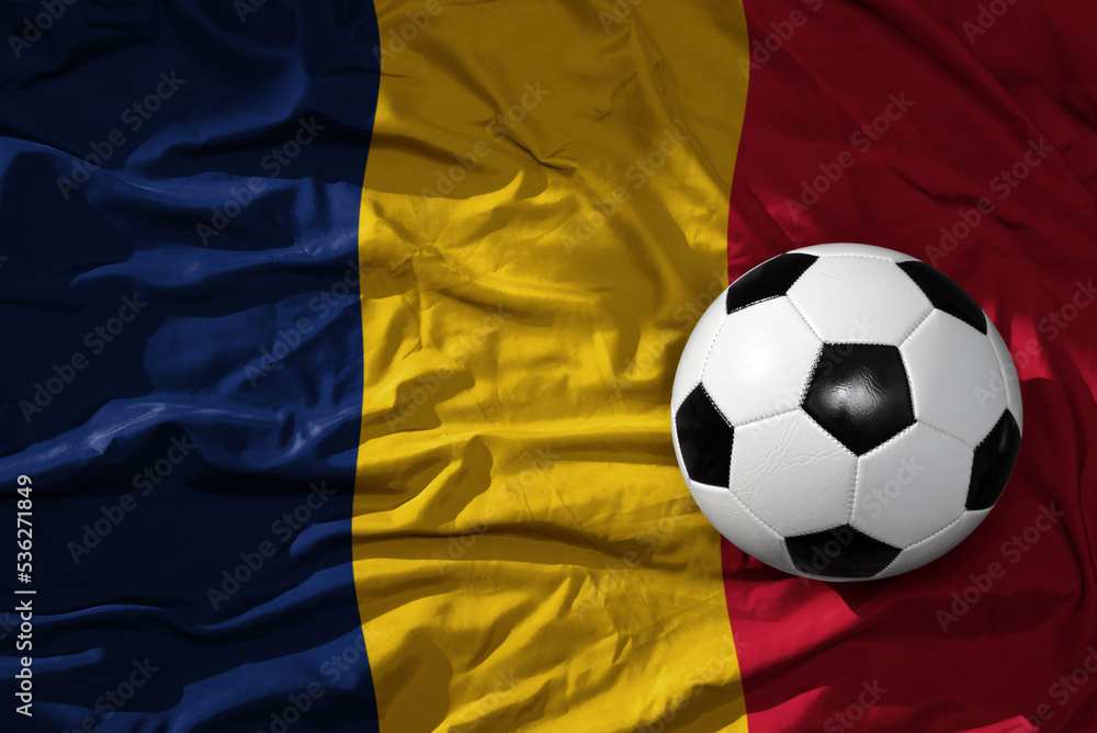 Naklejka premium vintage football ball on the waveing national flag of chad background. 3D illustration