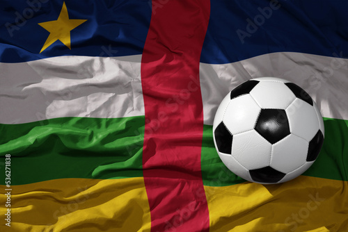 vintage football ball on the waveing national flag of central african republic background. 3D illustration