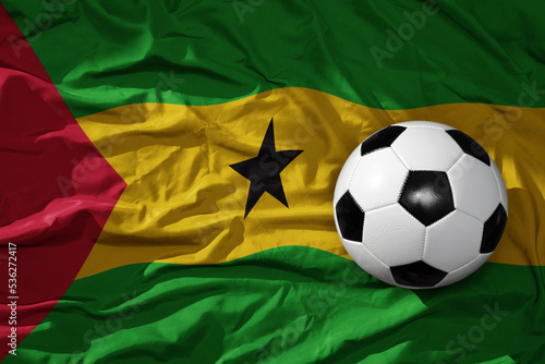 vintage football ball on the waveing national flag of sao tome and principe background. 3D illustration