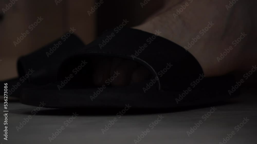 man puts on slippers getting out of bed man puts on slippers getting out of bed
