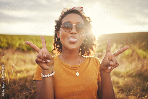 Nature, freedom and peace hand sign by woman at sunset in the countryside, happy and content while traveling, Portrait, grass and black woman having fun on road trip, taking break in rural landscape