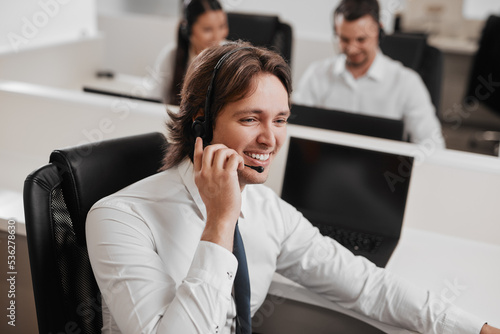 Friendly call center operator talking with client
