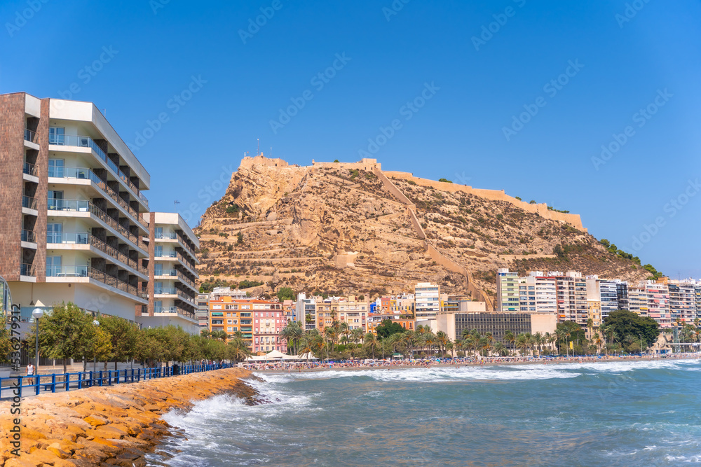 Postiguet beach in the city of Alicante on a summer afternoon and the Castle of Santa Barbara