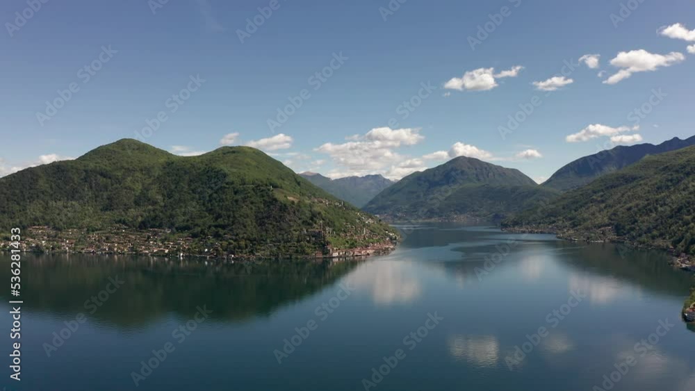Aerial View of Lake Lugano from Porto Ceresio in Italy and surrounding mountains in a beautiful cloudy day Aerial View of Lake Lugano from Porto Ceresio in Italy and surrounding mountains in a beautiful cloudy day