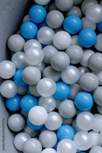Blue and gray plastic balls for children. Toy pool for fun.