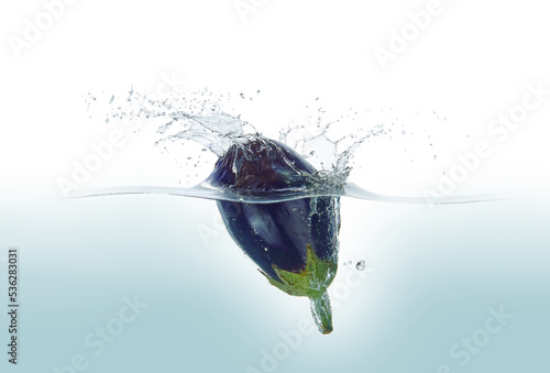 Aubergine splashing in water.