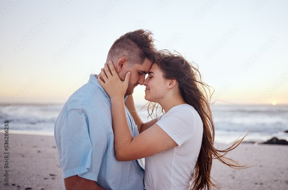 Couple, love and beach at sunset with face in hands for travel, vacation or holiday by the sea. Man, woman and ocean show happiness, smile and care together by waves, sand and summer sunshine in Bali Couple, love and beach at sunset with face in hands for travel, vacation or holiday by the sea. Man, woman and ocean show happiness, smile and care together by waves, sand and summer sunshine in Bali