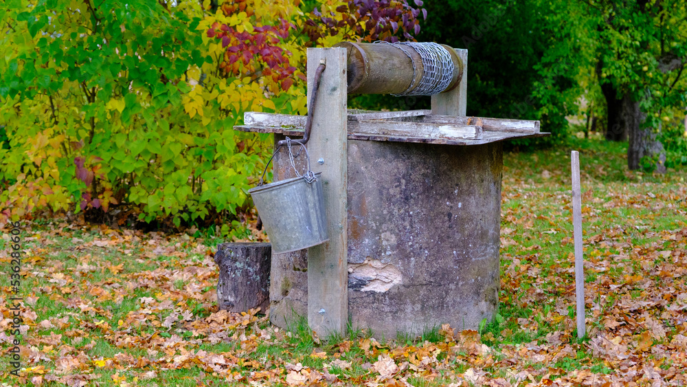 The old homestead well. Well, about water. The main source of water for agriculture. Sunny autumn day. Old retro looks traditional good. The old homestead well. Well, about water. The main source of water for agriculture. Sunny autumn day. Old retro looks traditional good.