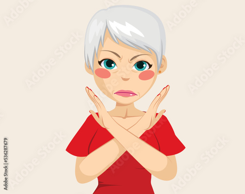 Senior woman making refuse gesture with crossed arms. Stressed adult lady feeling angry