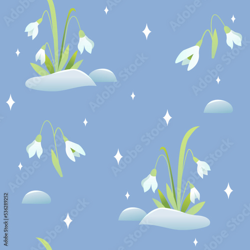 Spring flowers seamless pattern on a blue. Lovely snowdrops background. 