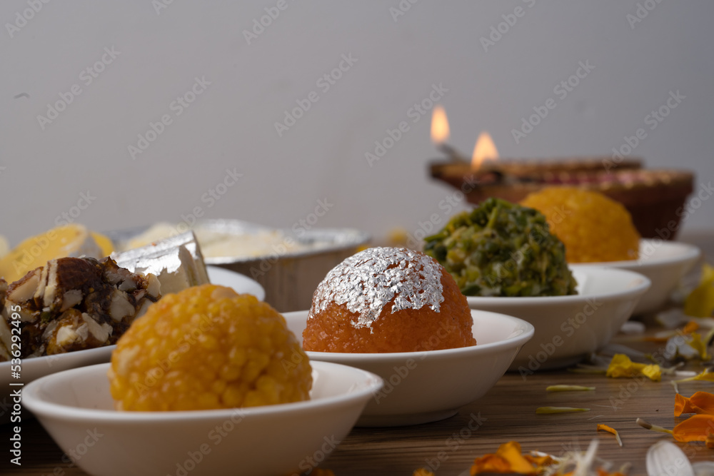 Mix indian sweets like kaju roll dryfruits barfi mango peda served in a plate Mix indian sweets like kaju roll dryfruits barfi mango peda served in a plate