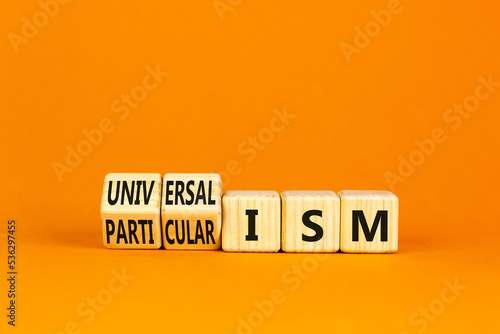 Universalism or particularism symbol. Concept words Universalism or Particularism on cubes. Beautiful orange table orange background. Business universalism or particularism concept. Copy space. photo