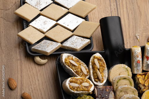 Group of Indian assorted sweets or mithai with diya

 photo