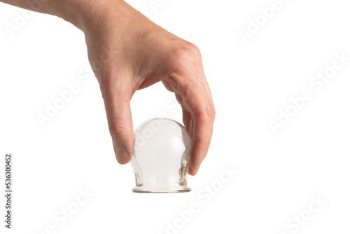 Εκτύπωση καμβά A hand holding a glass cup for cupping therapy, isolated on white, close-up