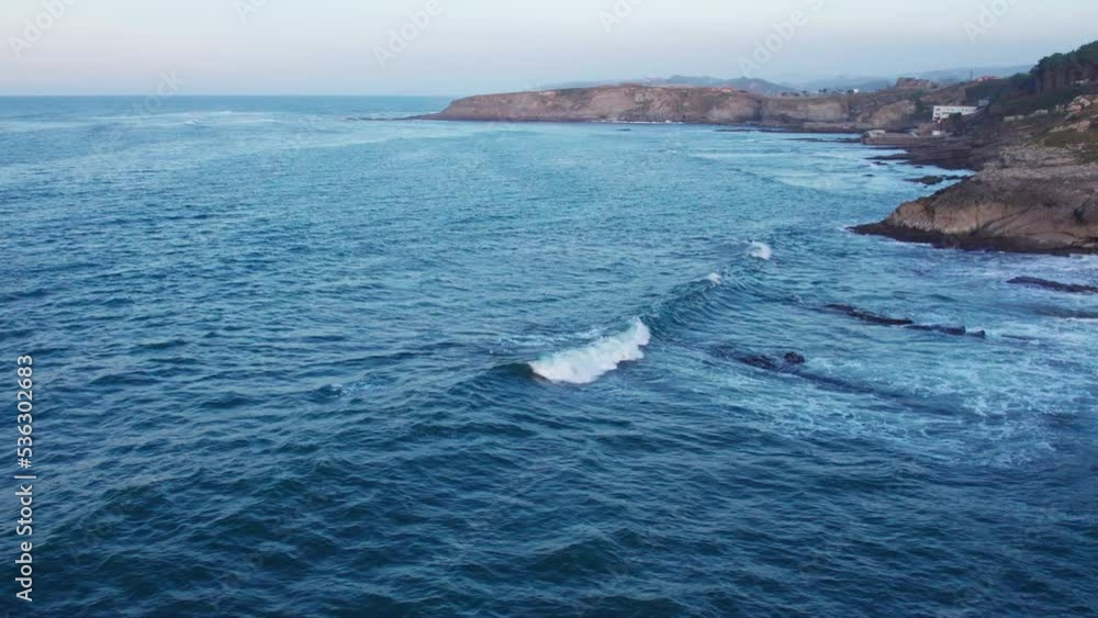 Drone Flying Towards Rocky Hill On Blue Sea Bay, Comillas Coast, Spain Drone Flying Towards Rocky Hill On Blue Sea Bay, Comillas Coast, Spain
