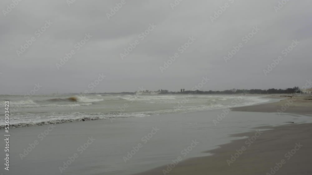 Cloudy Mediterranean beach after storm with sea waves Cloudy Mediterranean beach after storm with sea waves