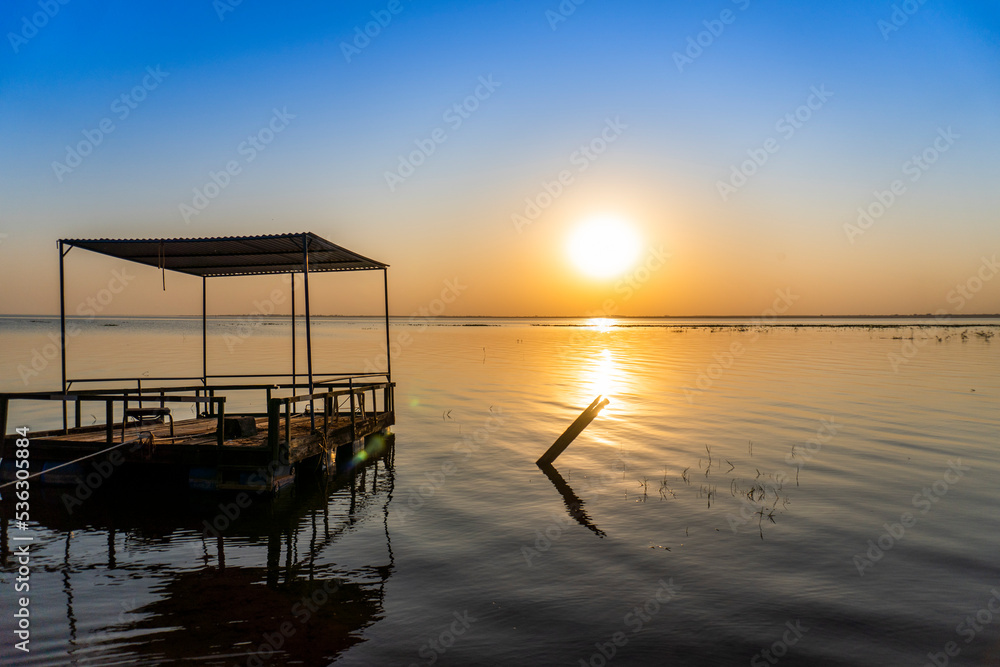 sunset by the river with boat