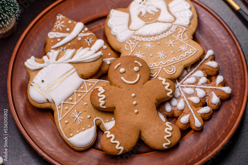 Christmas decoration elements as well as gingerbread on a brown concrete background