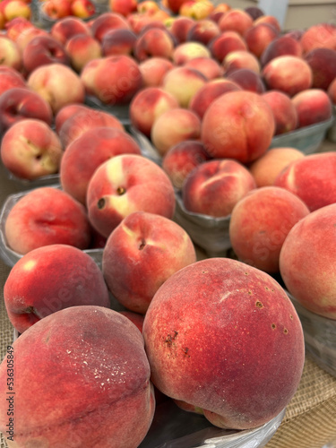 Photography Baskets of freshly harvested peaches for sale at a roadside farm stand in New Yo