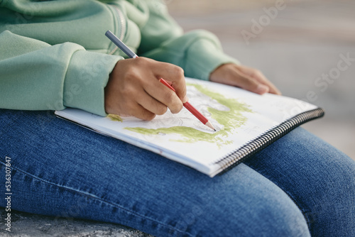 Zoom, hand, art student drawing or sketch illustration in notebook for painting exhibition, creative work or design academy class. Paper, creativity and girl artist planning painting on building roof