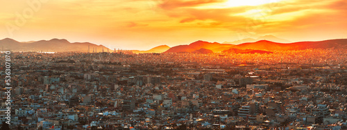 Roof top View at Residential areas of Athens, the capital of European country Greece, during epic sunset. Panoramic view.