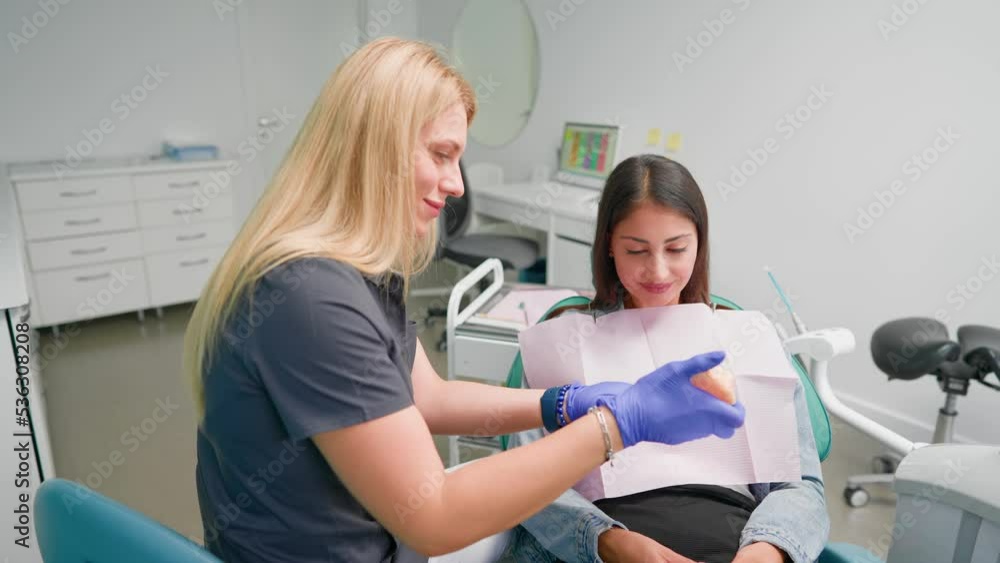 Professional Woman Dentist Examines a Female Patient and Prescribes
