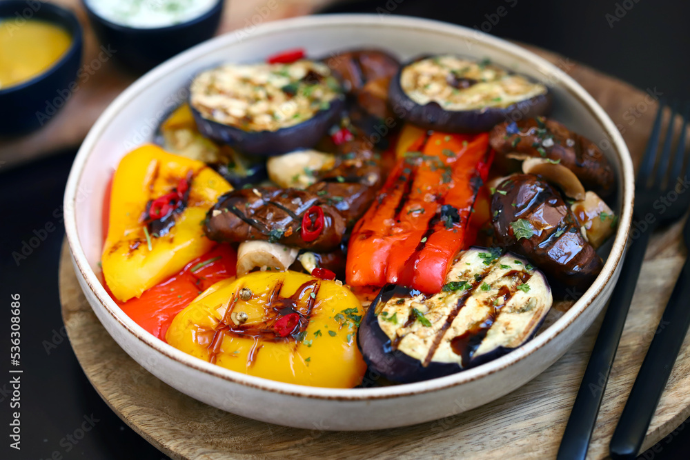 Grilled vegetables on a plate. Healthy food. Appetizing grilled peppers, eggplant, mushrooms. Grilled vegetables on a plate. Healthy food. Appetizing grilled peppers, eggplant, mushrooms.