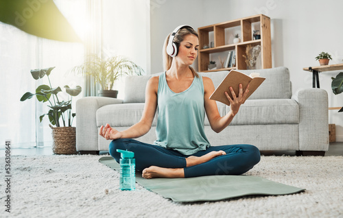Φωτογραφία Meditation yoga, calm music and woman reading a book while listening to podcast on the living room floor of a house