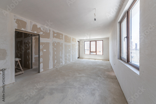 New empty room under construction. Plaster walls. New home. Interior renovation.