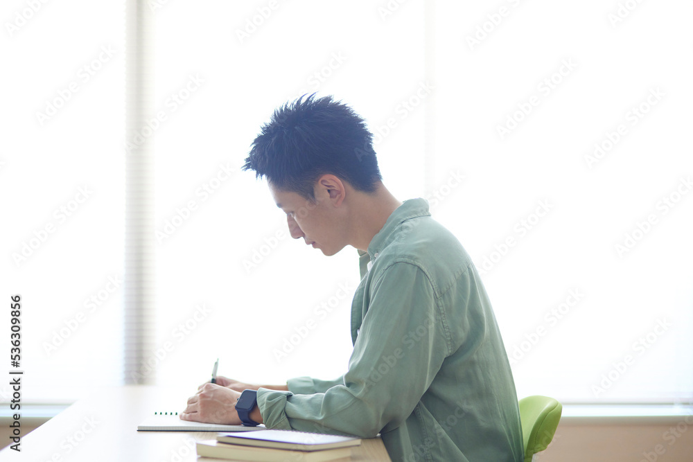 教室で勉強をする若い日本人の学生 教室で勉強をする若い日本人の学生