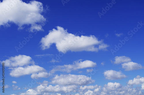 The blue sky with fluffy clouds in summertime