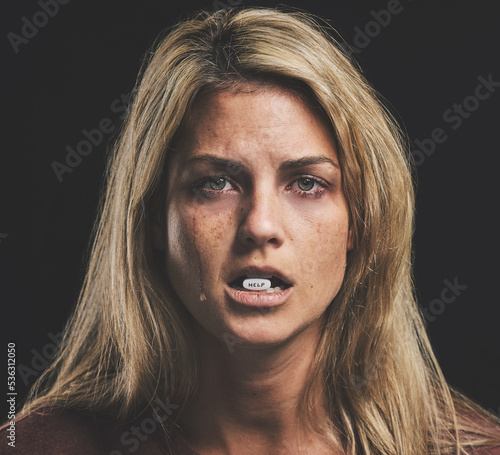 Woman, depression and sad with pills in mouth for mental health, psychology or stress. Girl, anxiety and crying for help with bipolar, paranoid or addiction with medicine in lips for wellness of mind