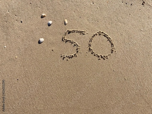 On the beach in the sand is carved the number 50 © Marcus